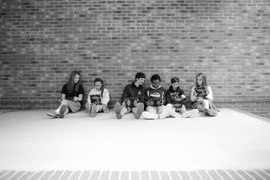 Students in uniform with 1:1 devices at school