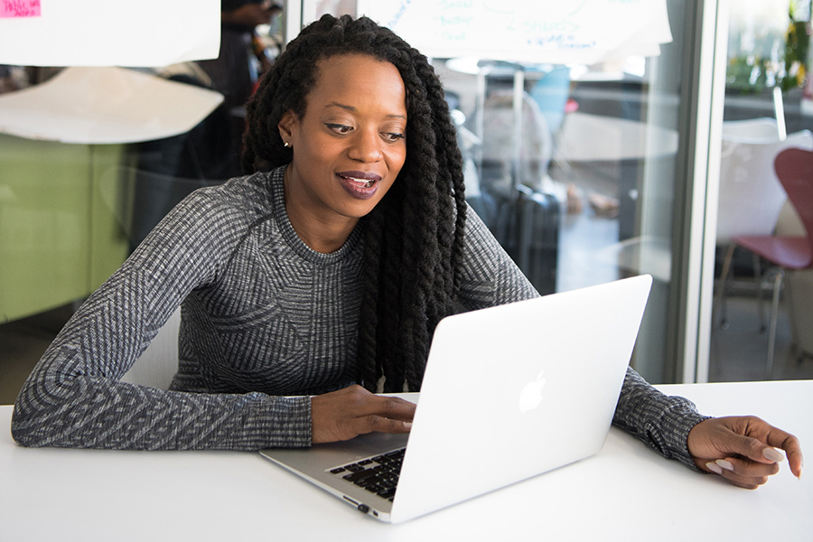 Image of woman on laptop in conversation